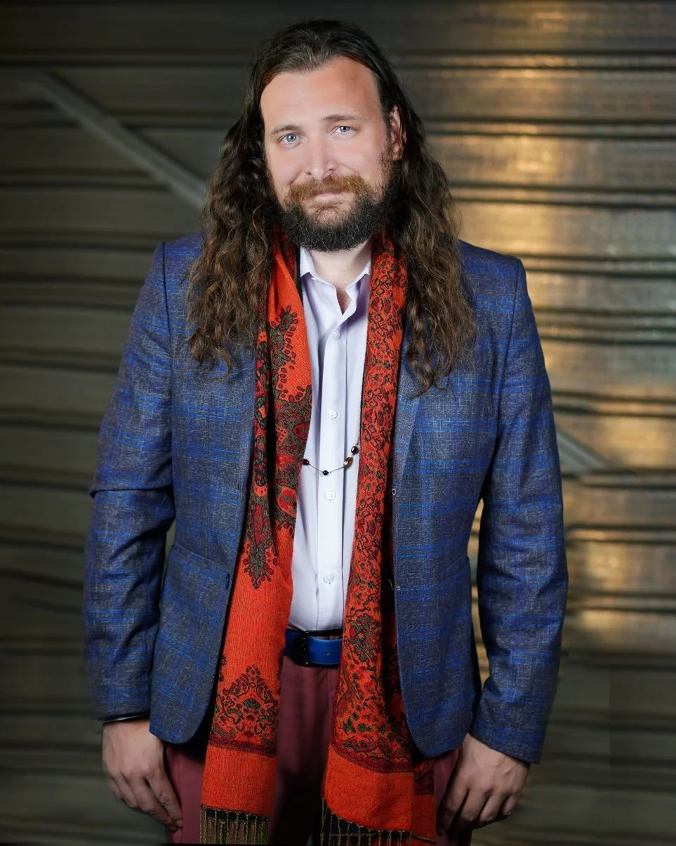 Erik Fuhrer, writing workshop facilitator, in a blazer and pink pants