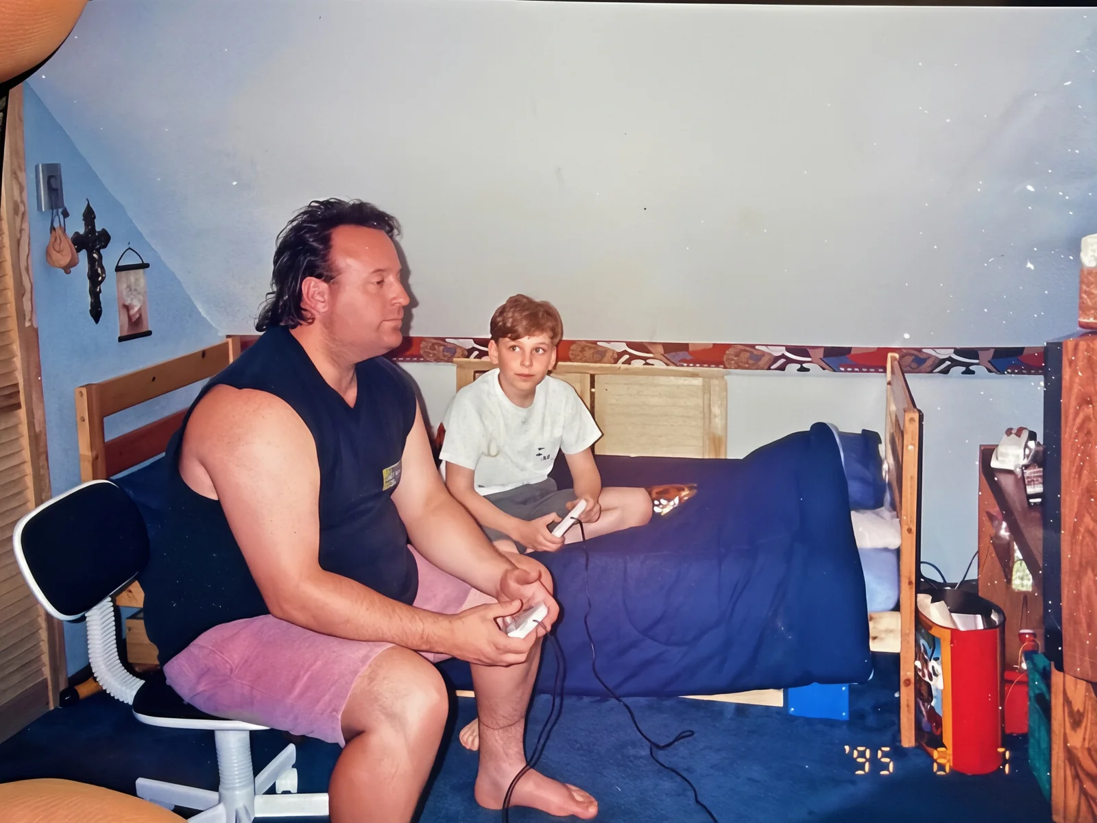 Erik as a kid playing video games with his dad